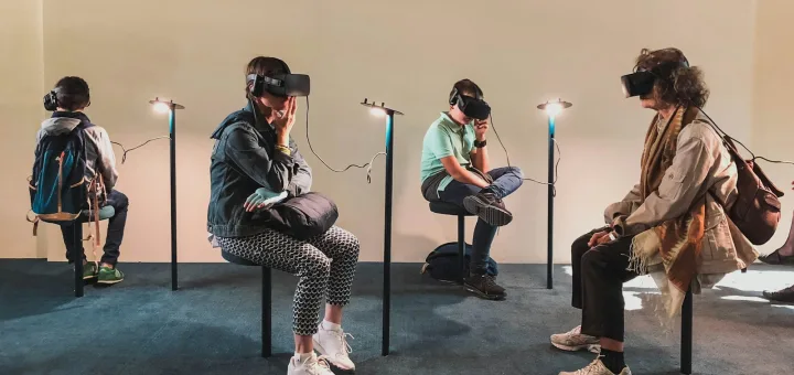 four person playing virtual reality goggles